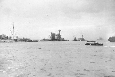 Two cruisers sunk as breakwaters at Normandy - nearer is the Dutch Sumatra, the further is Dragon